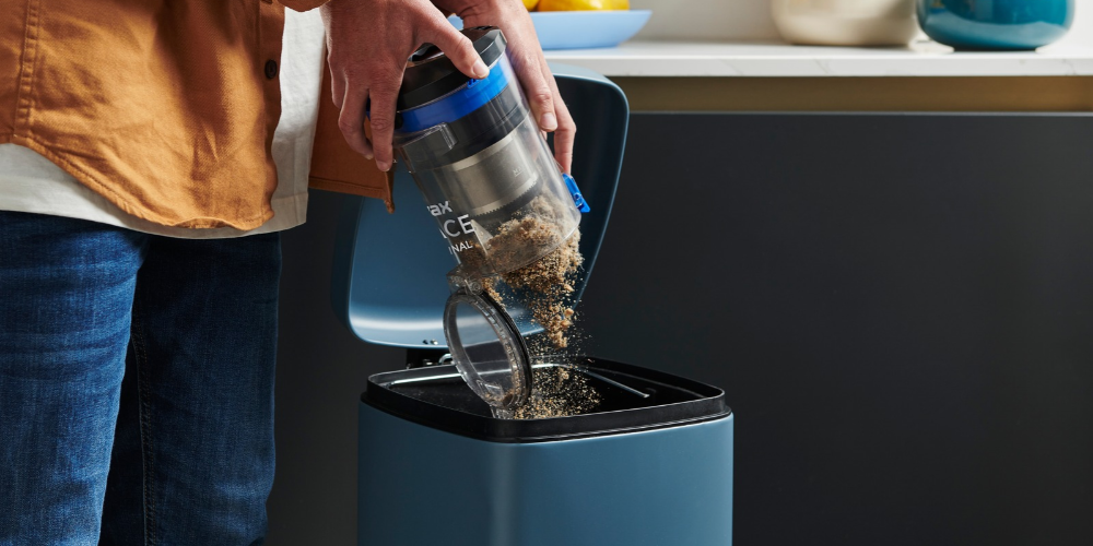 Emptying the dust compartment of a Vax vacuum cleaner