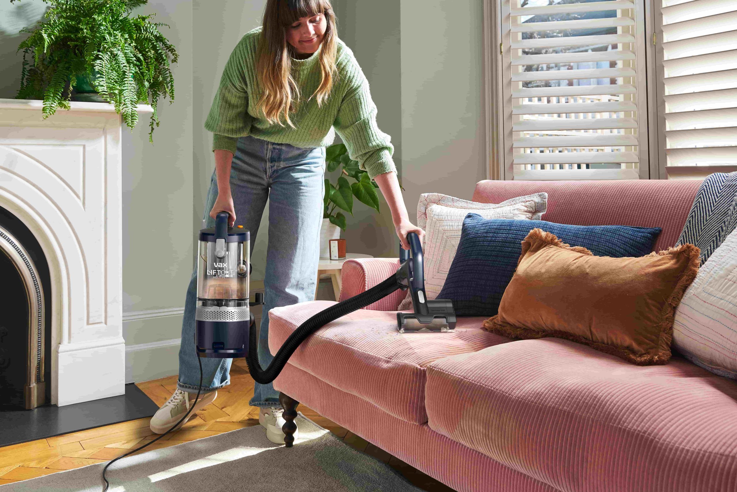 Woman vacuuming with a Vax vacuum cleaner
