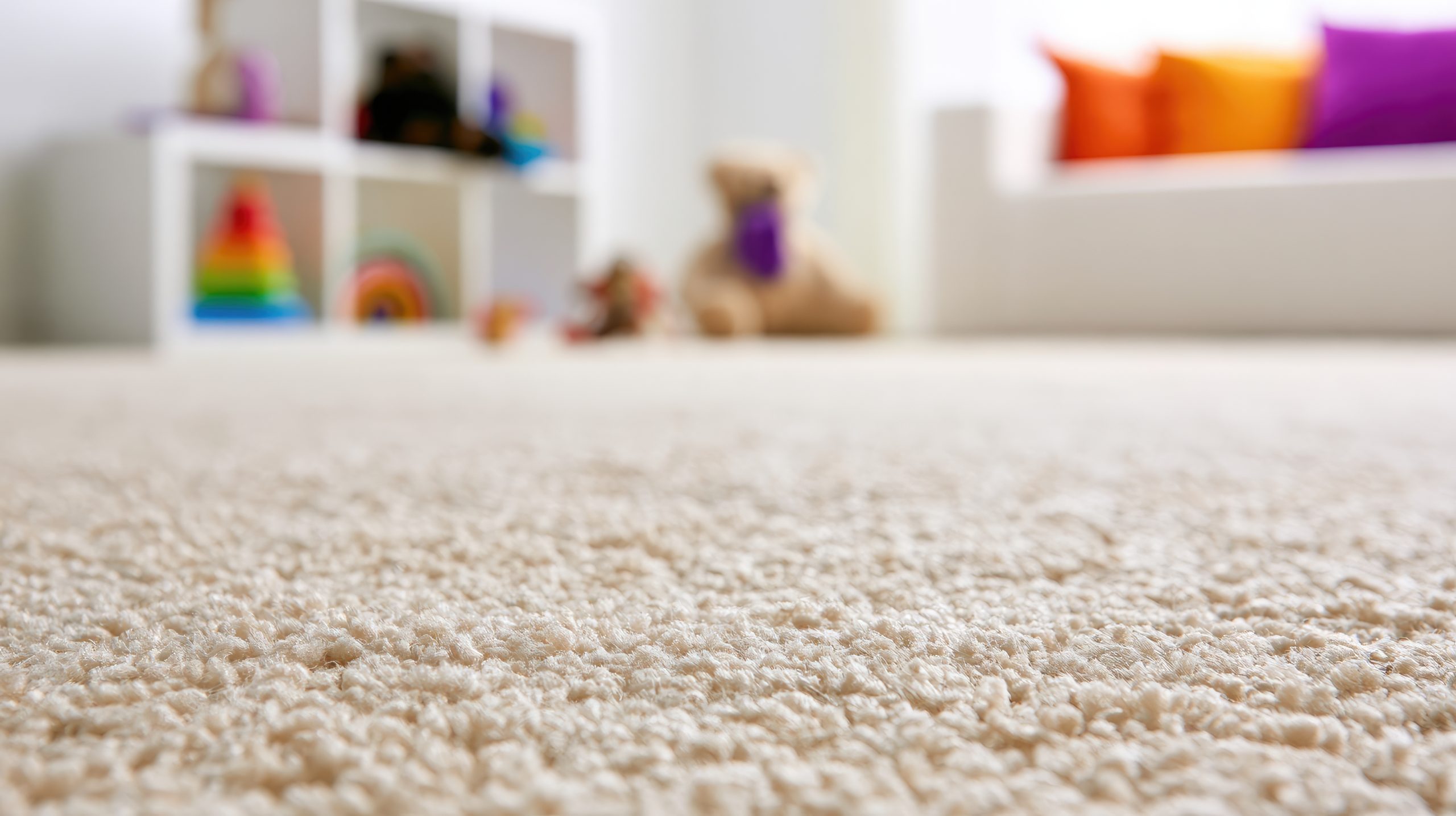 A close-up of a clean beige carpet in a child's bedroom