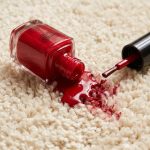 Red nail varnish spilled on a pristine beige carpet
